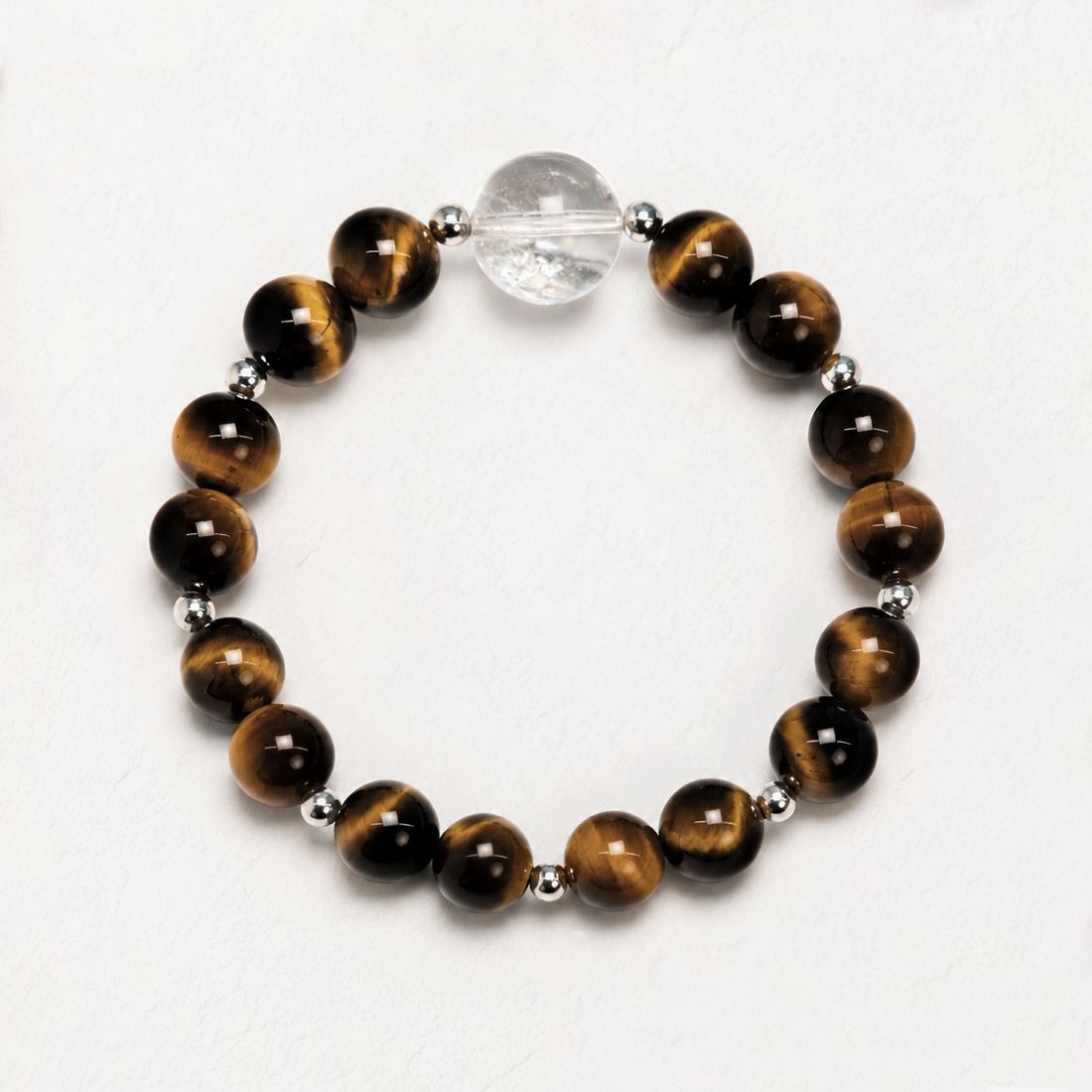 Sunlit Resolve Bracelet Sunlit Resolve natural crystal bracelet with Golden Tiger’s Eye and Clear Quartz on a white background.